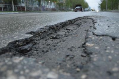 В одном из районов Киева посреди дороги провалился асфальт (ВИДЕО)